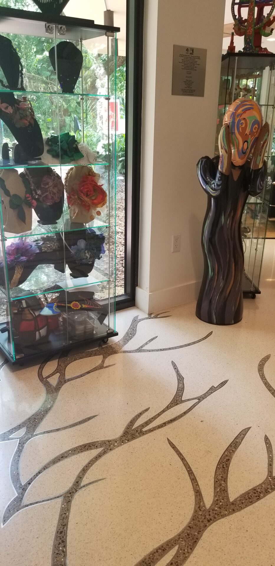 A room with a glass case and a statue