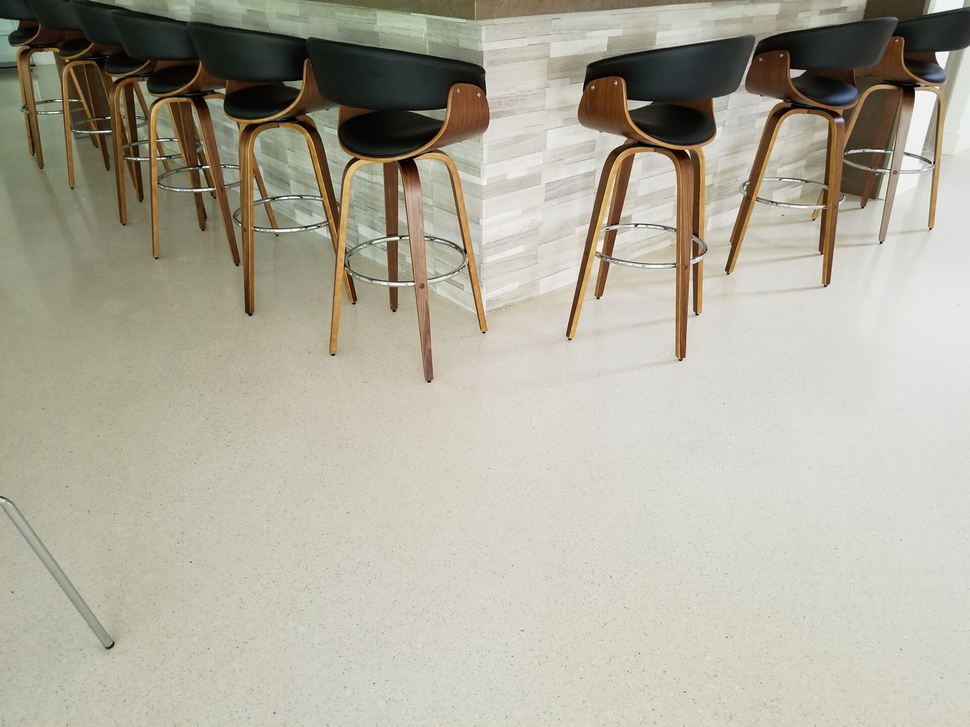 A group of chairs sitting in front of a counter.