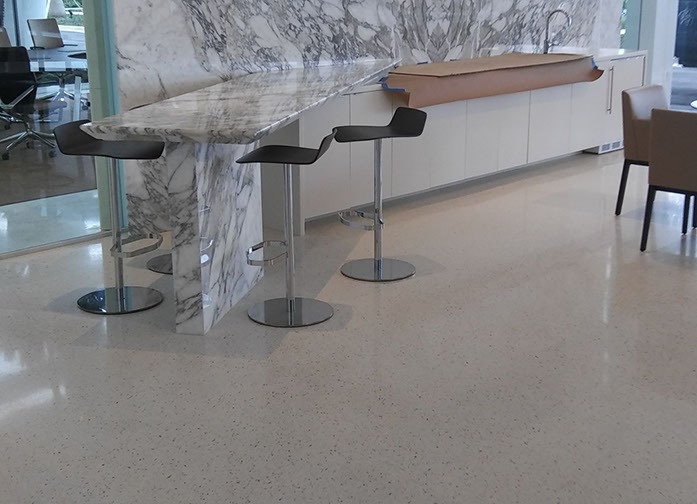 A room with three stools and a counter.