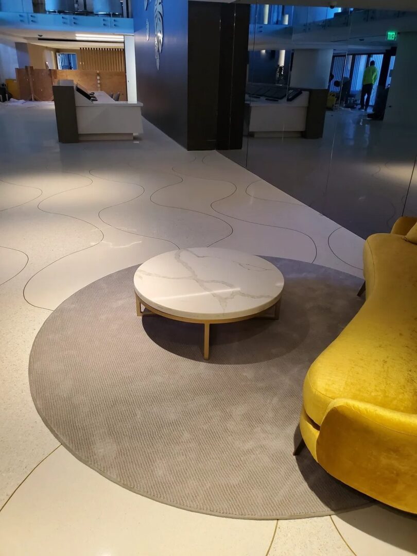 A yellow couch and ottoman in the middle of a room.