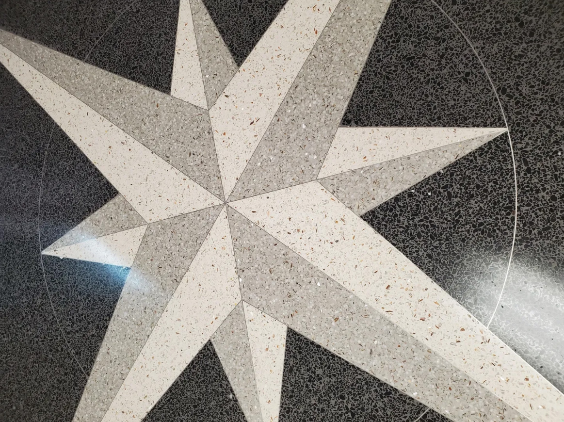 A star is painted on the floor of a building.