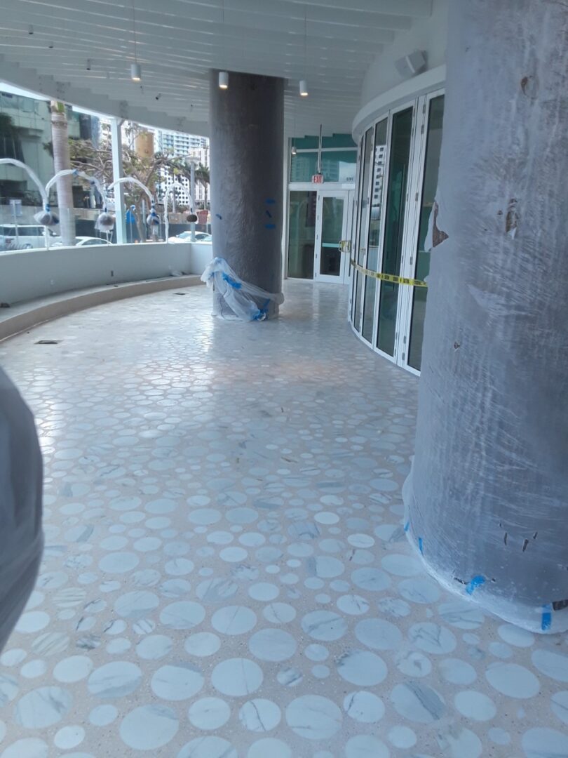 A walkway with white tiles and blue paint.