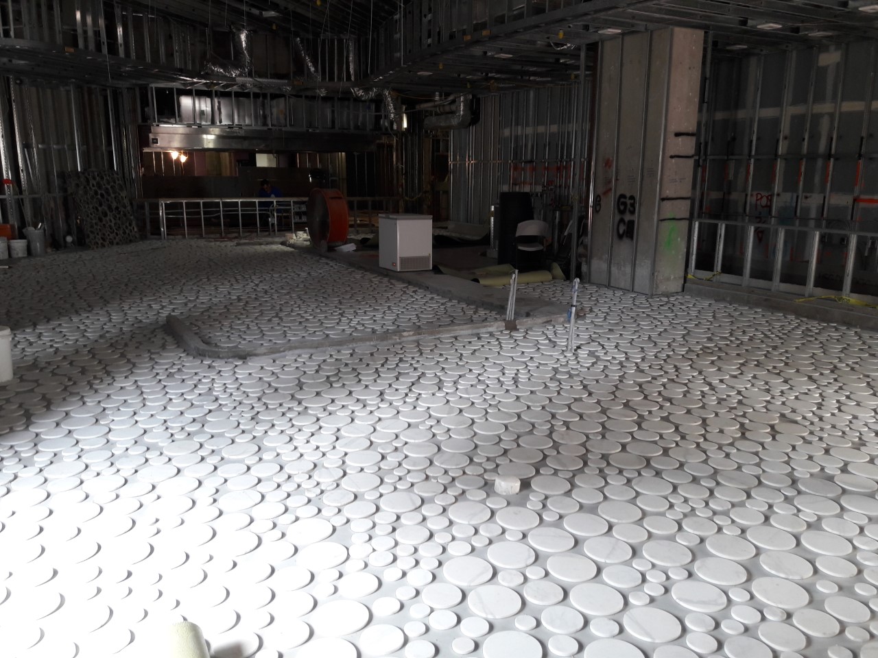 A room with many white cups on the floor