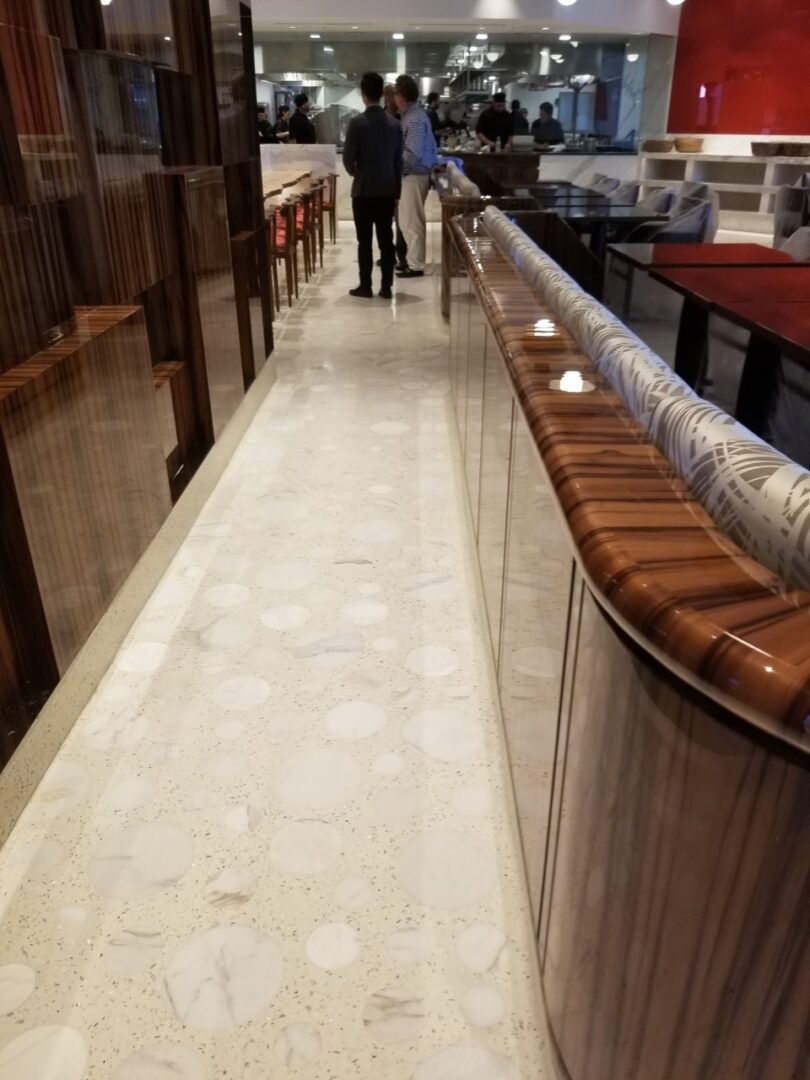 A person walking down the hall way of a restaurant.