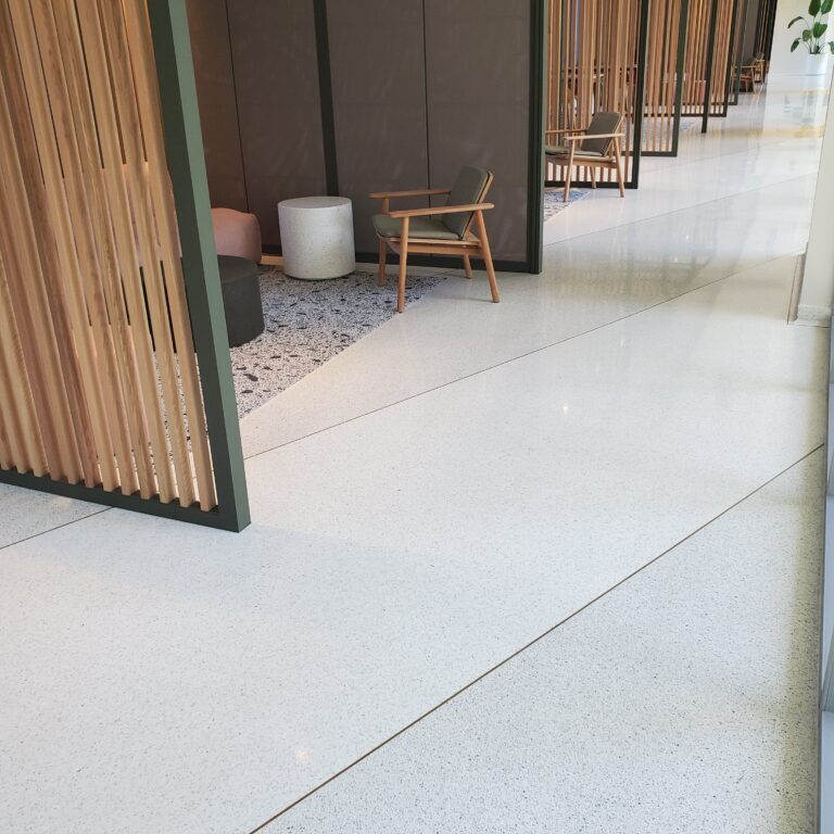 A walkway with wooden slats and concrete floors.